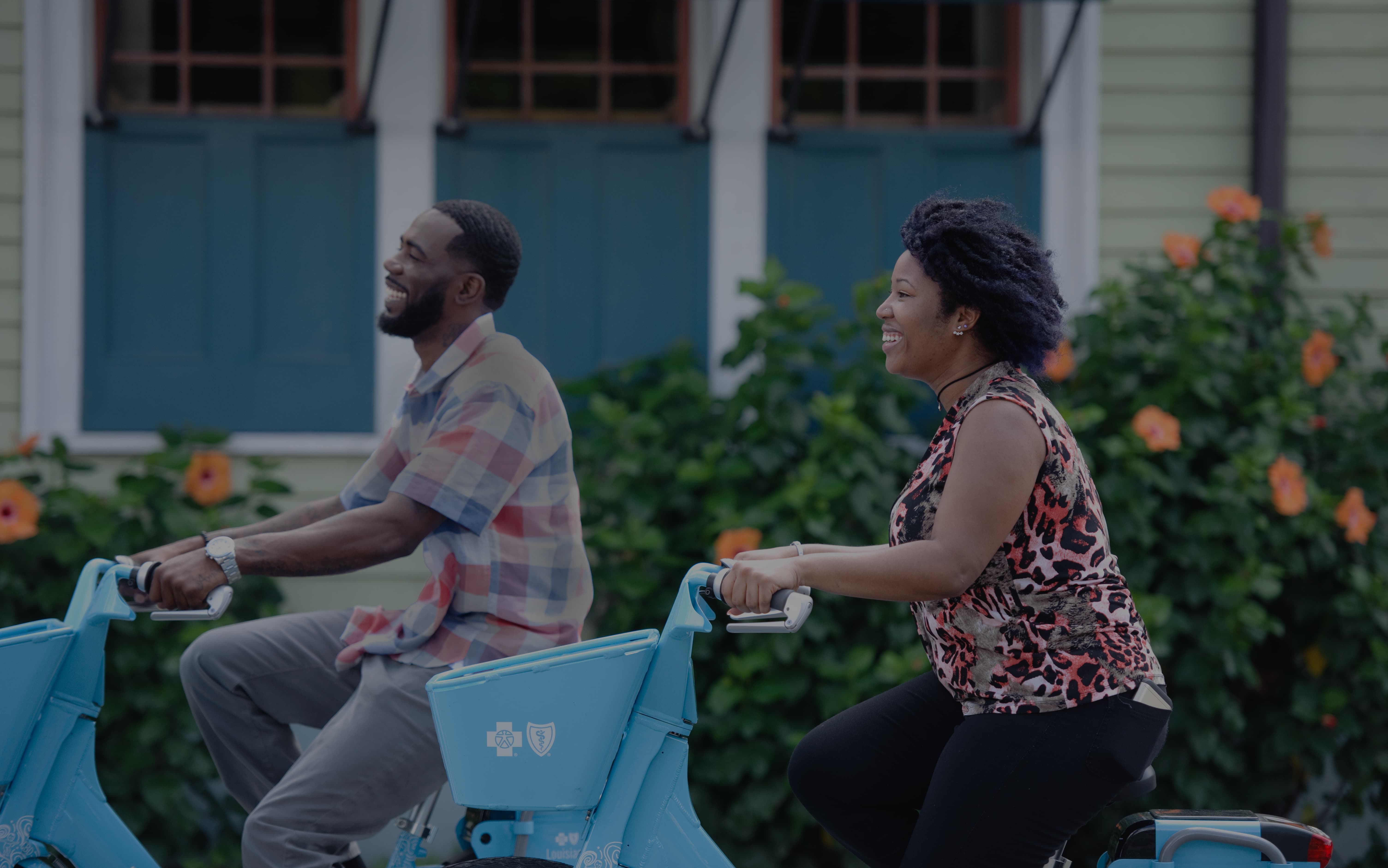 Two people riding Blue Bikes